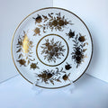 Antique French porcelain cake plate, from Paris, teaturing intricate hand-decorated gold floral motits on a white background.